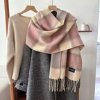 plaid fringe scarf in soft pink and beige, draped over gray coat on hanger, polyester one-piece imported