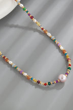 multicolored bead necklace with freshwater pearls featuring crystal and bead accents, delicate gold spacer beads and a pink pearl pendant