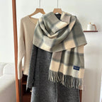 Alt Tag: plaid fringe scarf in gray and cream plaid pattern with tassel fringe, draped on a coat for cozy winter style