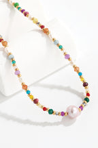 Alt Tag: multicolored bead necklace with freshwater pearls featuring crystal and bead accents, colorful strand with pearl pendant on white display